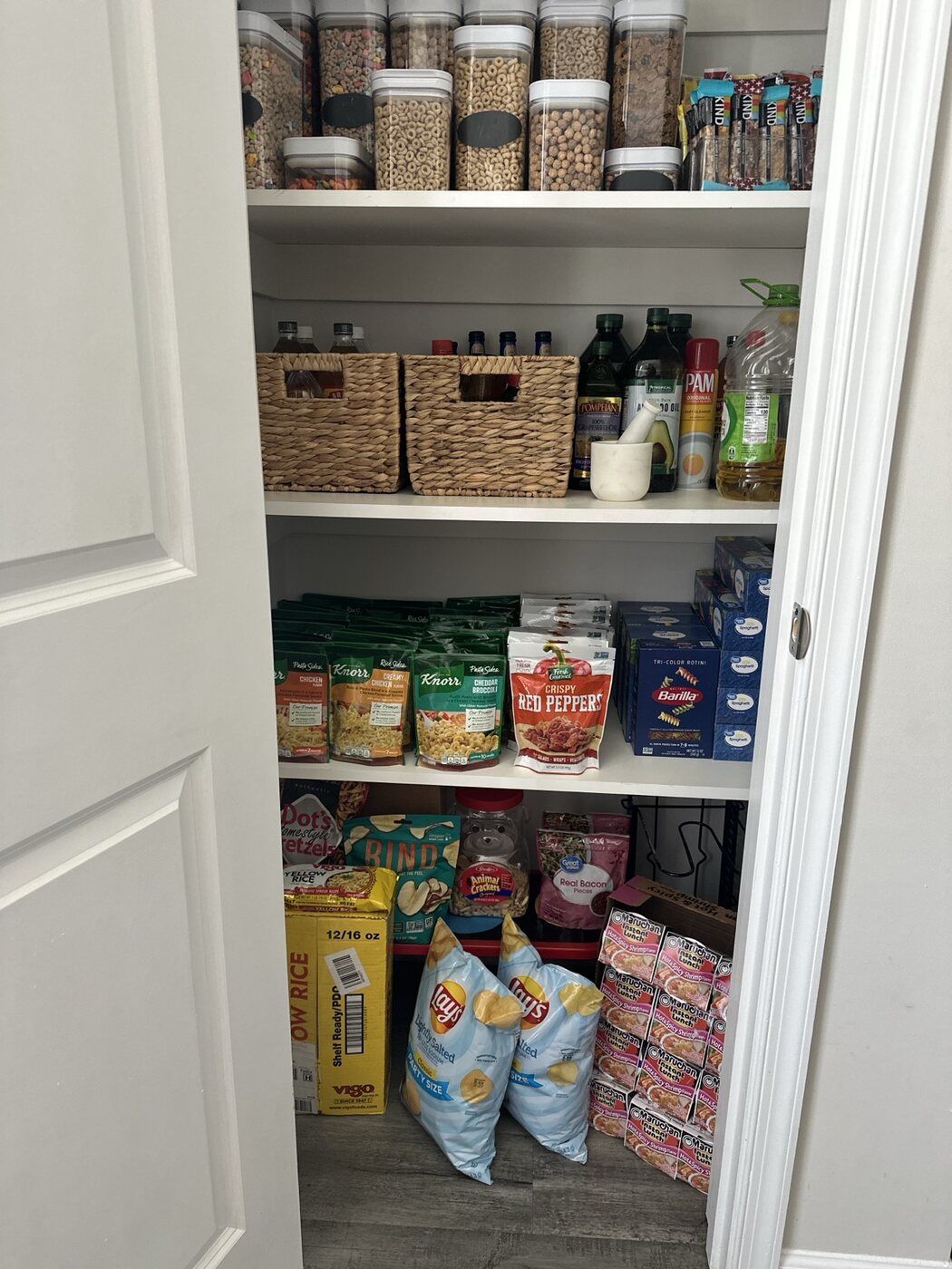 Organized pantry shelves and food storage by Versaux
